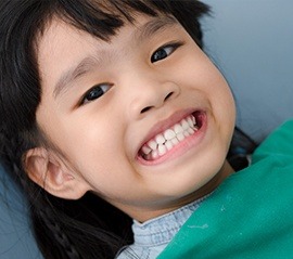 Young child smiling in dental chair