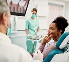 Woman with toothache visiting the emergency dentist in Fargo, MD