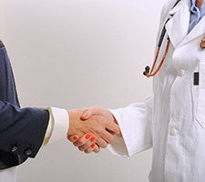 Patient and emergency dentist in Fargo, MD shaking hands