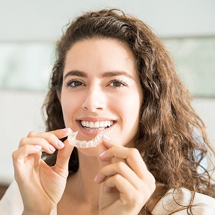 Woman placing her aligner tray