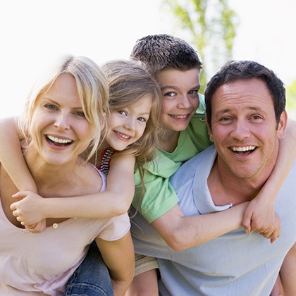 Family smiling after seeing dentist in Fargo