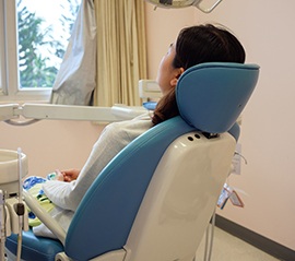 Back of woman relaxing in dental chair