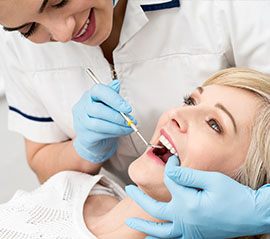 Woman receiving oral cancer screening