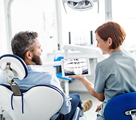 A patient talking to a dentist during a dental checkup in Fargo