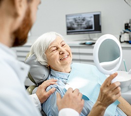 A woman getting her teeth cleaned as part of a dental checkup in Fargo
