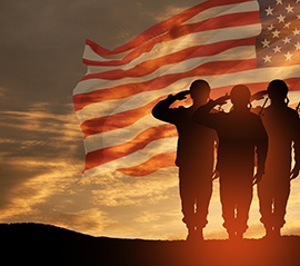 US Army soldiers saluting American flag