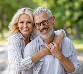 Couple smiling and wearing dentures in Fargo