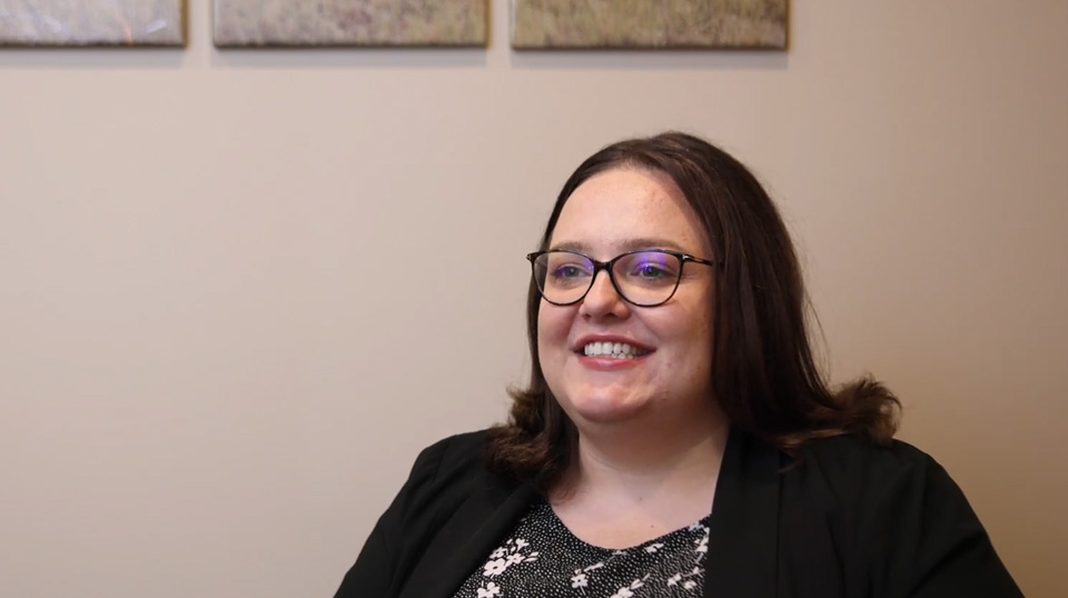 Fargo dentist placing her hand on the shoulder of a patient in dental chair