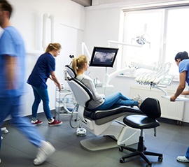 Dentists treating a patient’s dental emergency