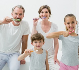 A family brushing their teeth together