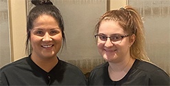 Two Cornerstone Dental team members smiling in Fargo dental office