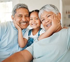Grandparents with their grandchild and smiling