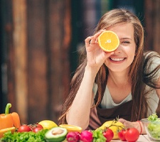 a woman eating healthy for dental implant care in Fargo