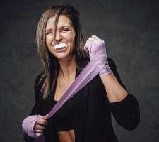 a woman wearing mouthguard for dental implant care in Fargo