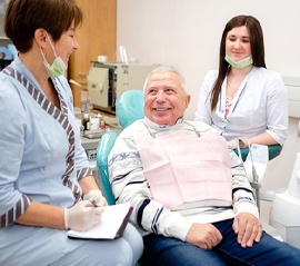 Senior man learning about his candidacy for implant dentures