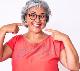 Happy woman enjoying the benefits of her implant dentures