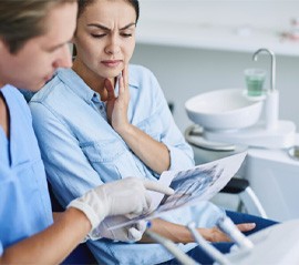 a dentist explaining how dental implants can fail