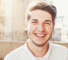 Man with dental implants in Fargo, ND outside smiling