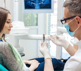 a dentist explaining dental implant technology.