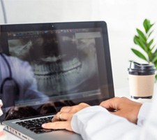 : a person looking at a digital impression of teeth 