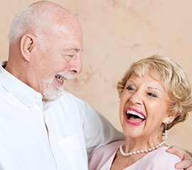 An older couple with dental implants Fargo laughing