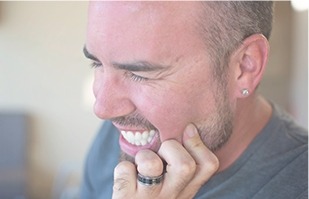 Man holding his jaw in pain