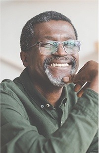 Older man with glasses smiling