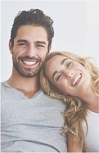 Young woman resting her head on shoulder of young man next to her