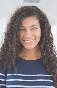 Young woman wearing a striped sweater and smiling