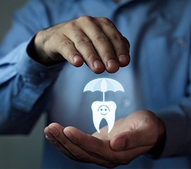 Hands holding an animated tooth under an umbrella