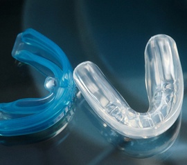 Close up of clear blue and white mouthguards