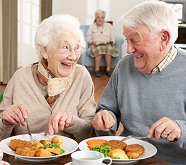 Older couple eating a meal together