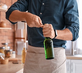 Waiter using bottle cap opener