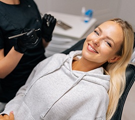 Patient reclined in treatment chair smiling