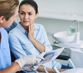 a patient speaking to dentist about a failed dental implant
