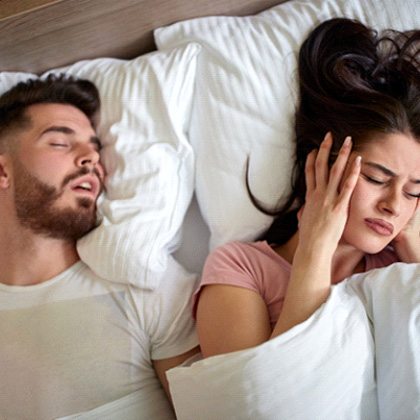 Man with sleep apnea in Fargo snoring next to wife