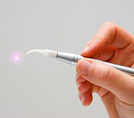 Hand holding a soft tissue laser tool