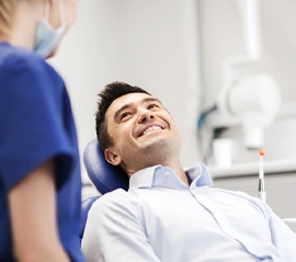 Man smiling at dentist discussing teeth whitening in Fargo