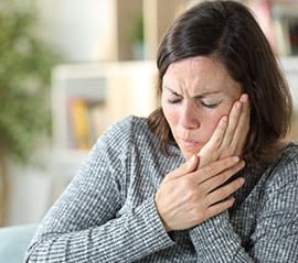 a woman with jaw discomfort in need of TMJ treatment