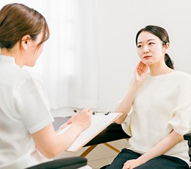 a patient visiting her dentist for TMJ treatment