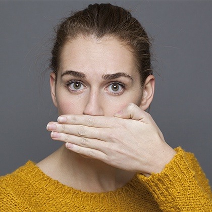 Woman covering her smile