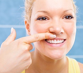 Woman looking at her gum tissue