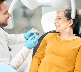 Woman visiting dentist about denture changes