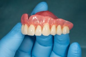 person holding dentures