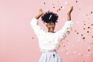 Woman throwing confetti after visiting Fargo dentist