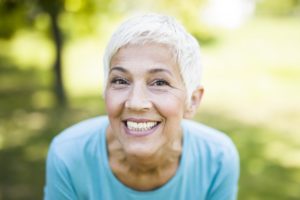 senior woman smiling after treatment with SureSmile for adults 