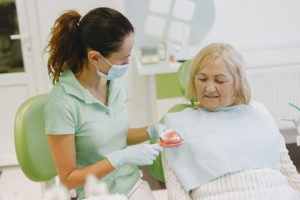 Older woman at appointment for dentures