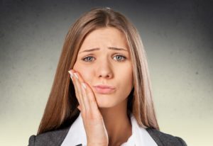 Woman in pain with her hand on her face