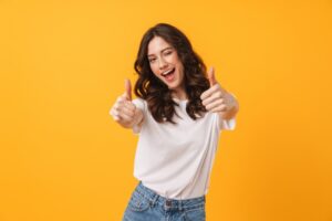 Woman smiling and holding thumbs up