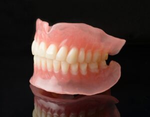 Full dentures against black background.